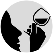 The silhouette of a person looking at a wine glass.
